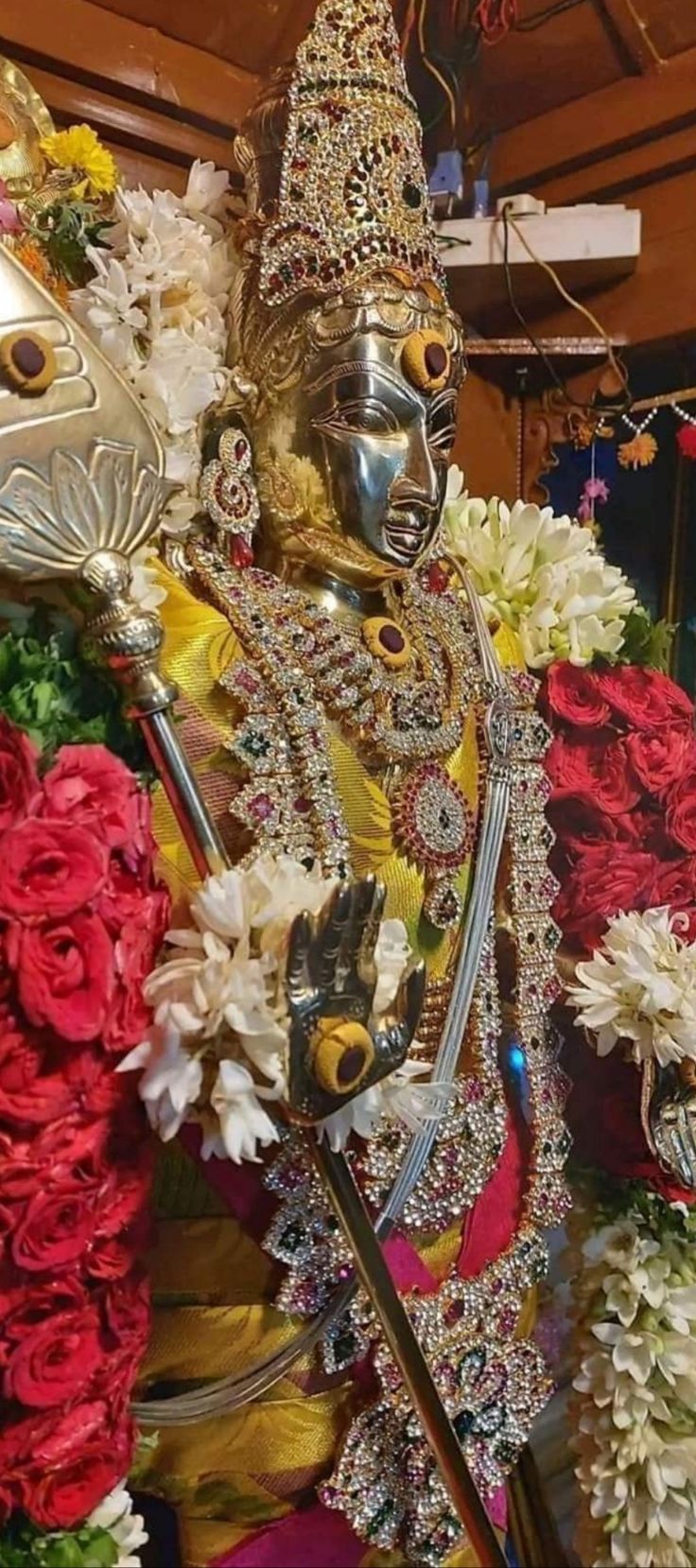 the statue is surrounded by flowers and other decorations