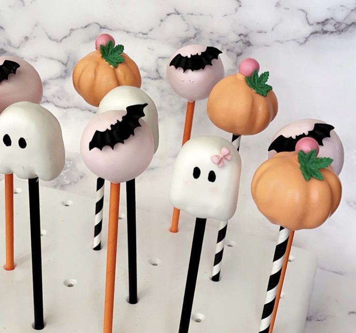 halloween cake pops with bats and pumpkins on them