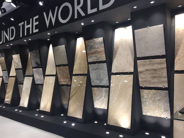 a display case filled with lots of different types of flooring tiles in front of a sign that says around the world