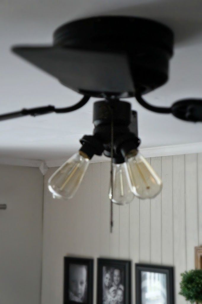 a ceiling fan with three light bulbs hanging from it