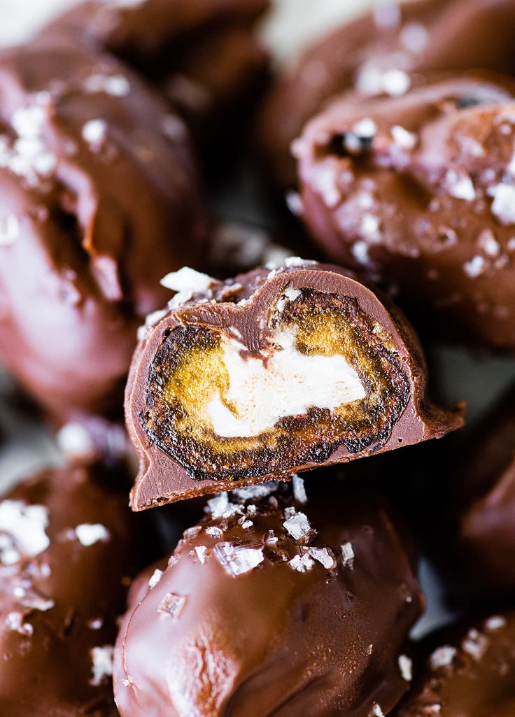 chocolate covered donuts with white sprinkles on top