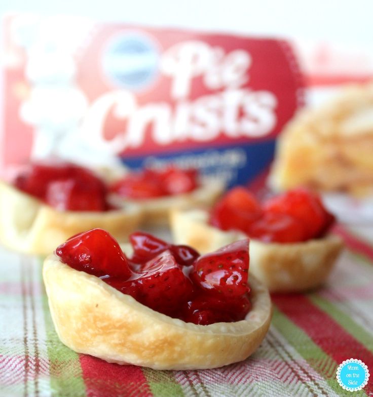 small pastries with strawberries in them on a table