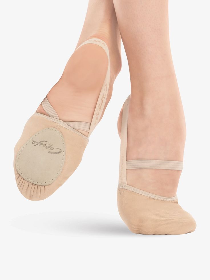 a woman's feet in ballet shoes with the bottom part of her shoe showing