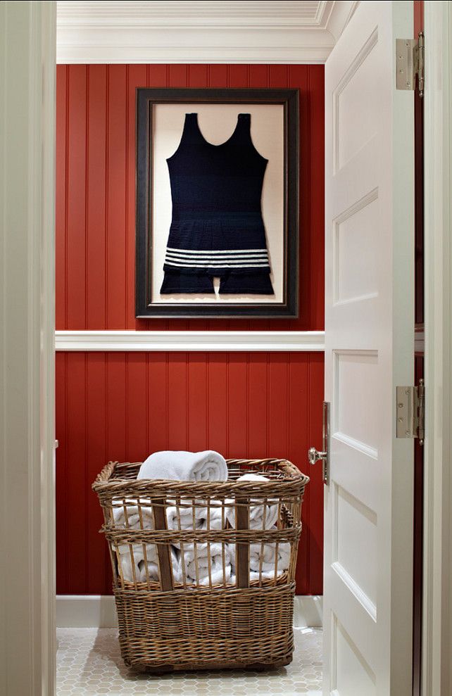 a laundry room with a basket in front of the door and a painting on the wall