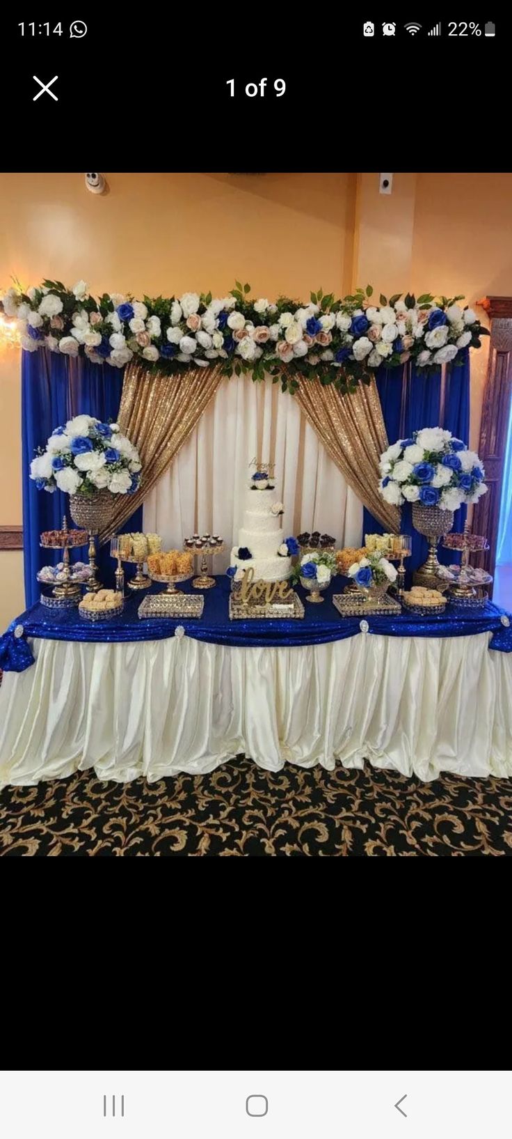 a blue and white dessert table with flowers on it