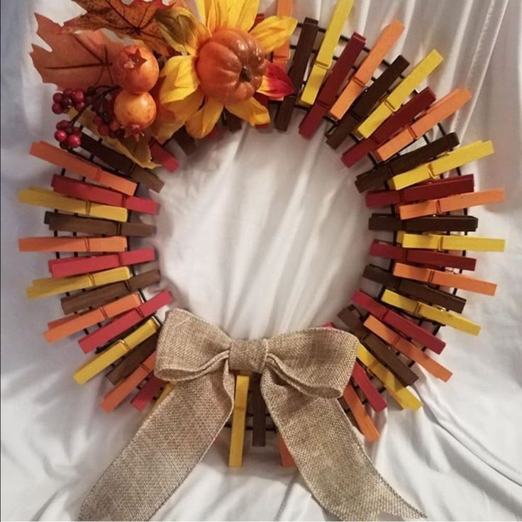 a wreath made out of popsicle sticks and fall leaves