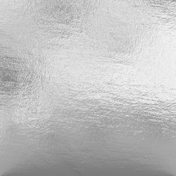 an abstract silver background with white and black highlights on the bottom half of the image