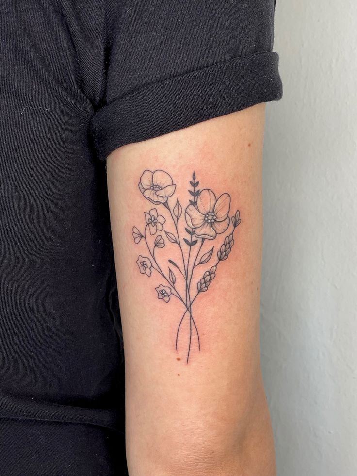 a woman with a flower tattoo on her arm