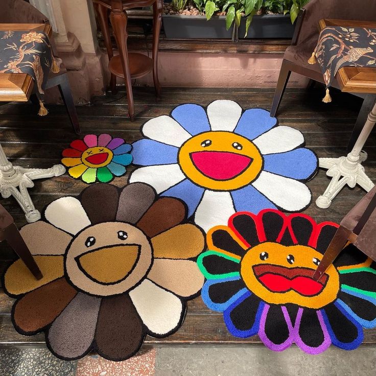 colorful rugs with flowers and faces on the floor