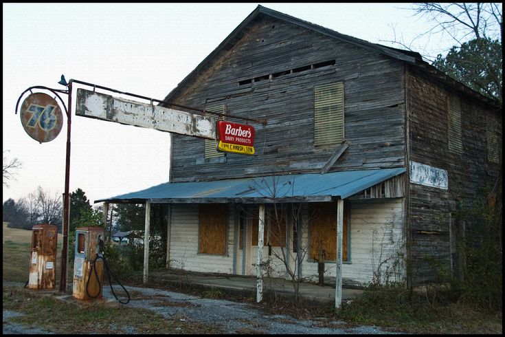 an old run down building with a sign on the front