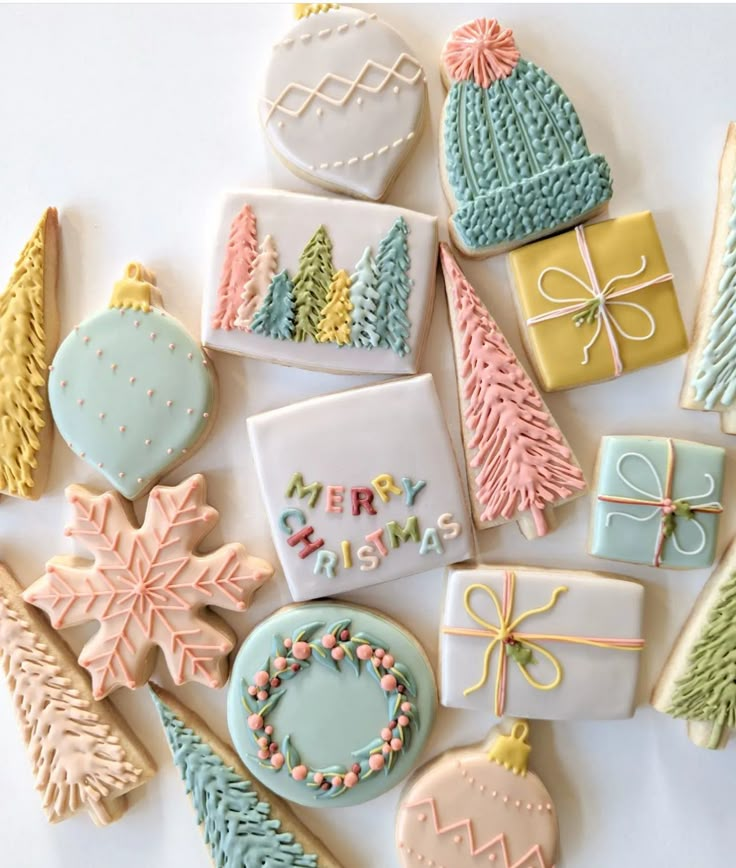 decorated cookies are arranged in the shape of christmas trees, gifts and snowflakes