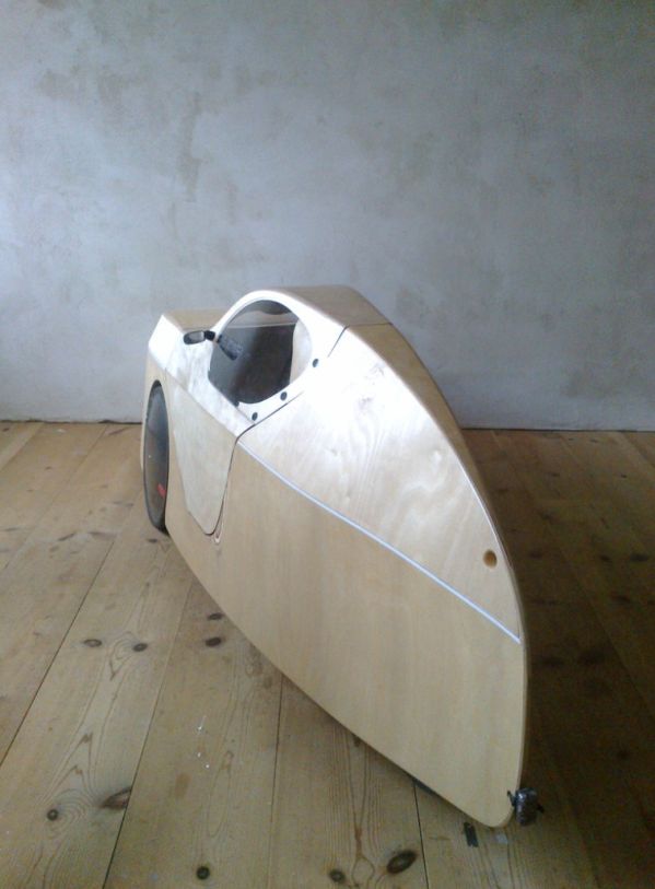 a small wooden boat sitting on top of a wooden floor