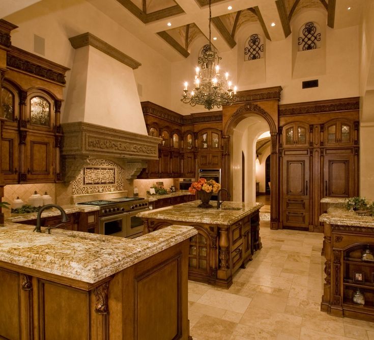 a large kitchen with marble counter tops and wooden cabinets, along with chandelier