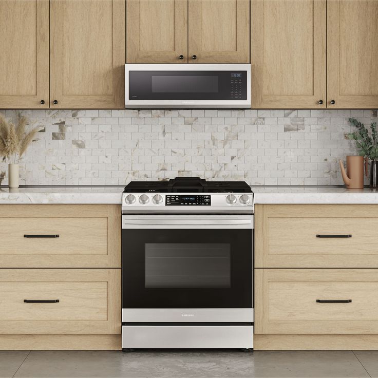 a stove top oven sitting inside of a kitchen next to wooden cabinets and counter tops