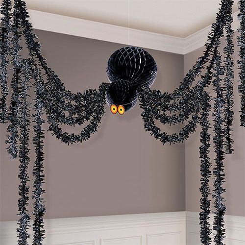 a room decorated in black and white with decorations hanging from it's ceiling for halloween