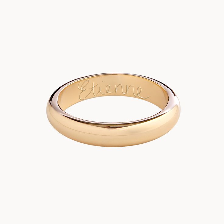 a gold ring with the word love engraved on it