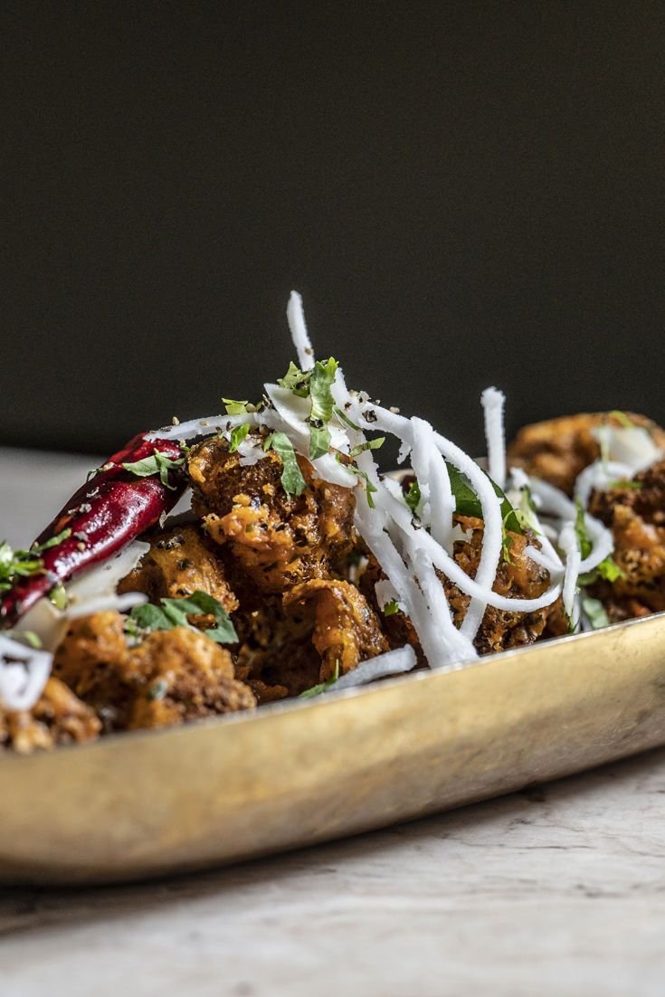 a wooden platter filled with food on top of a table