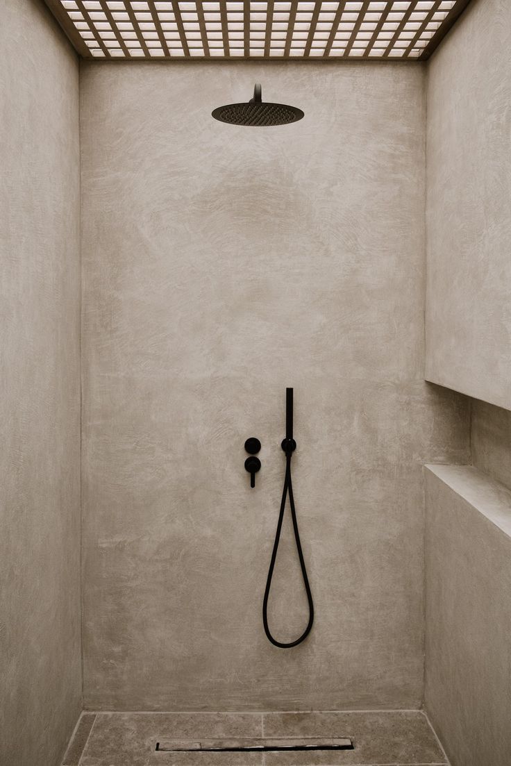 a shower head in the corner of a bathroom