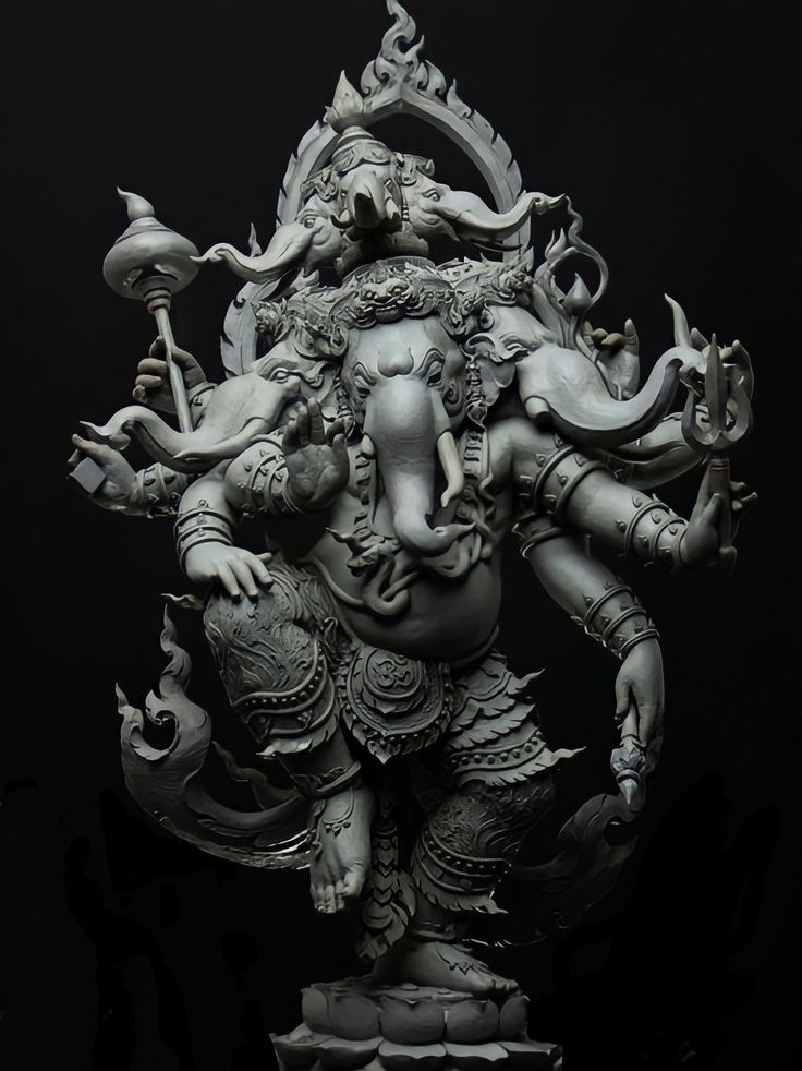 a statue of an elephant god in the middle of a dark room with black background