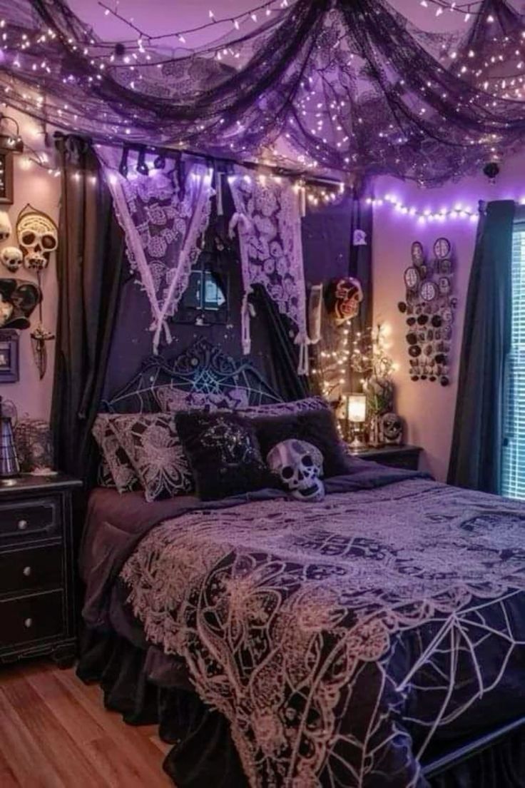 a bedroom decorated in purple and black with string lights