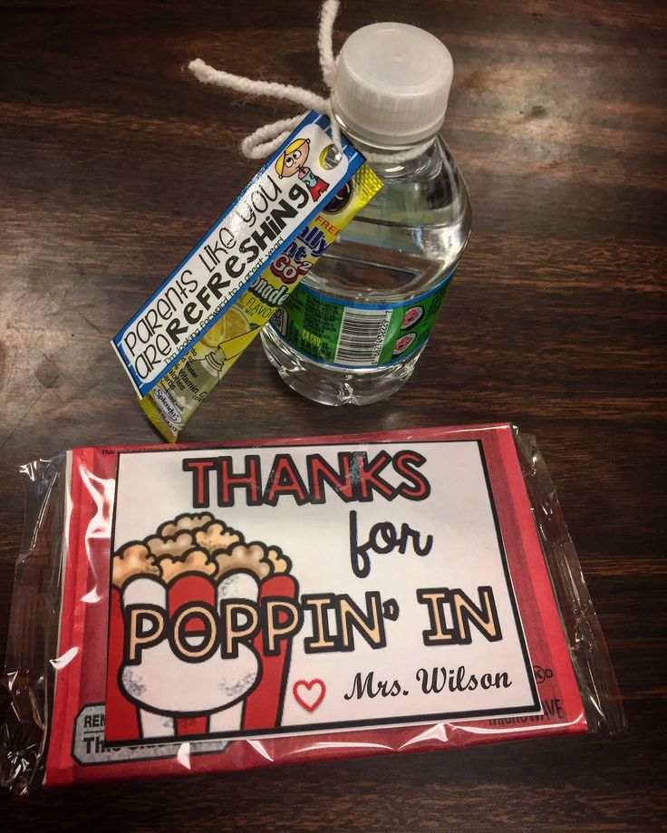 a bottle of popin'in water next to a sign that says thanks for popcorn