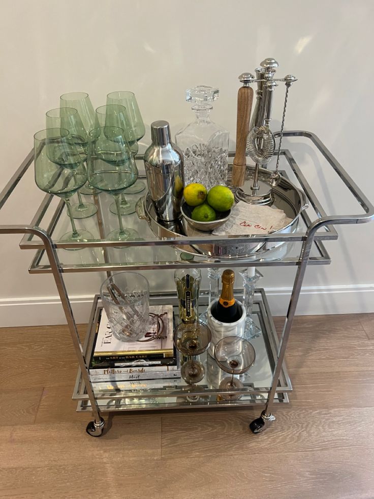 a bar cart filled with glasses and bottles