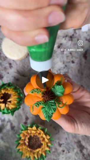 someone is decorating fake sunflowers with fondant and green glue on their fingers