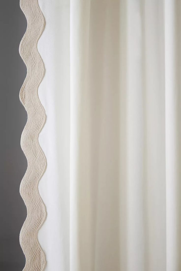 a white shower curtain with wavy lines on it