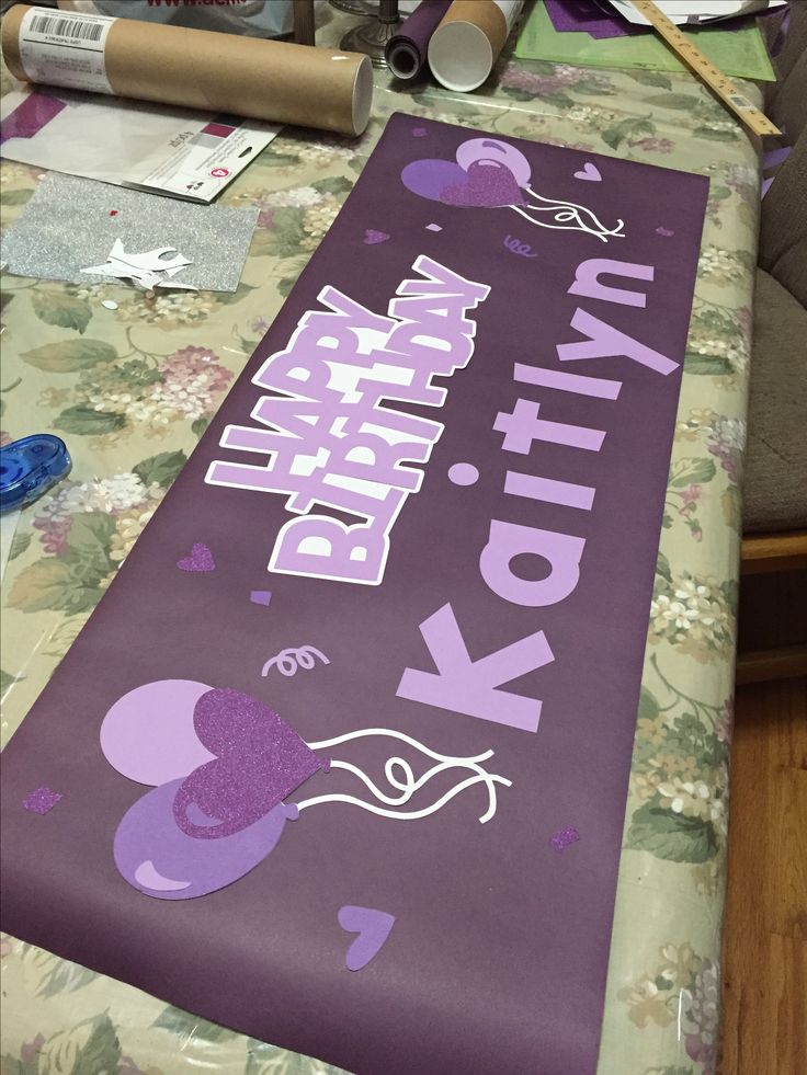 there is a purple birthday banner on the table