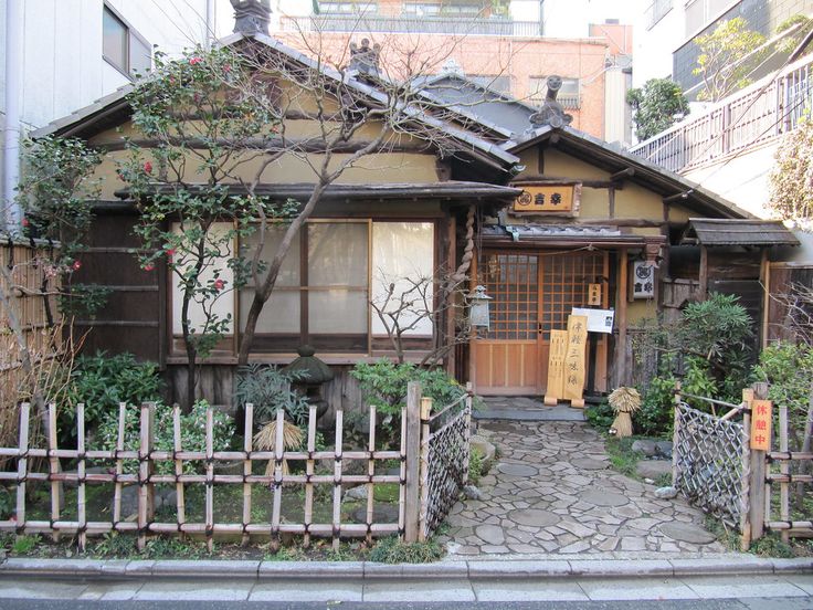 an old house with a wooden fence in front of it