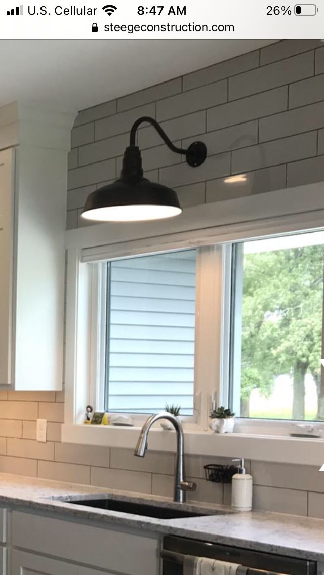 a kitchen with white cabinets and gray counter tops