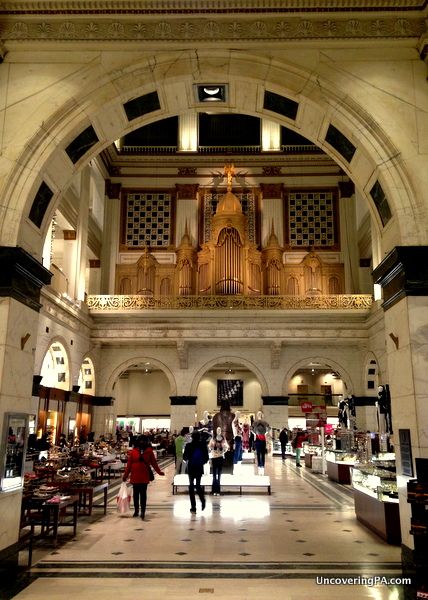 the inside of a building with people walking around