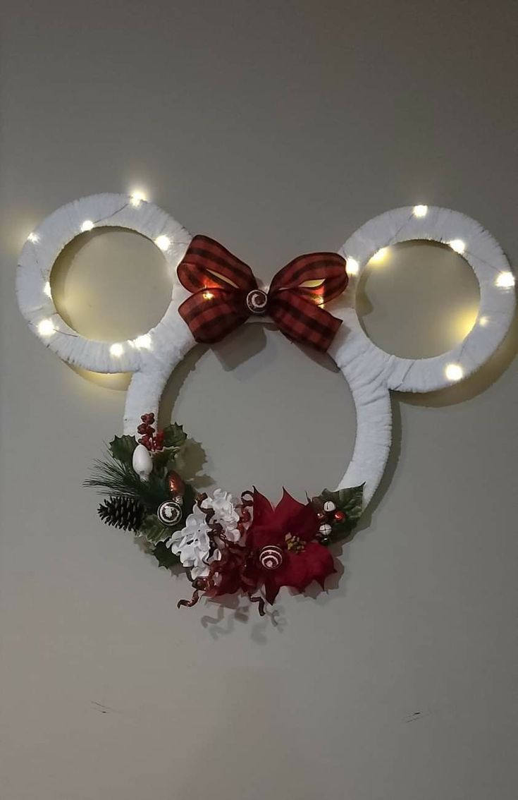 a mickey mouse head with lights on it's ears and decorations around the ears