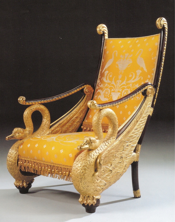 an ornately decorated chair with two swans sitting on it's back and arms