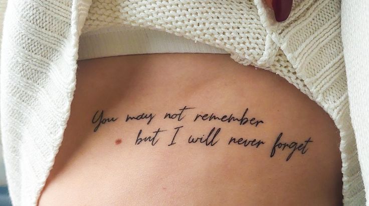 the back of a woman's stomach with a tattoo saying you may not remember but i will never forget