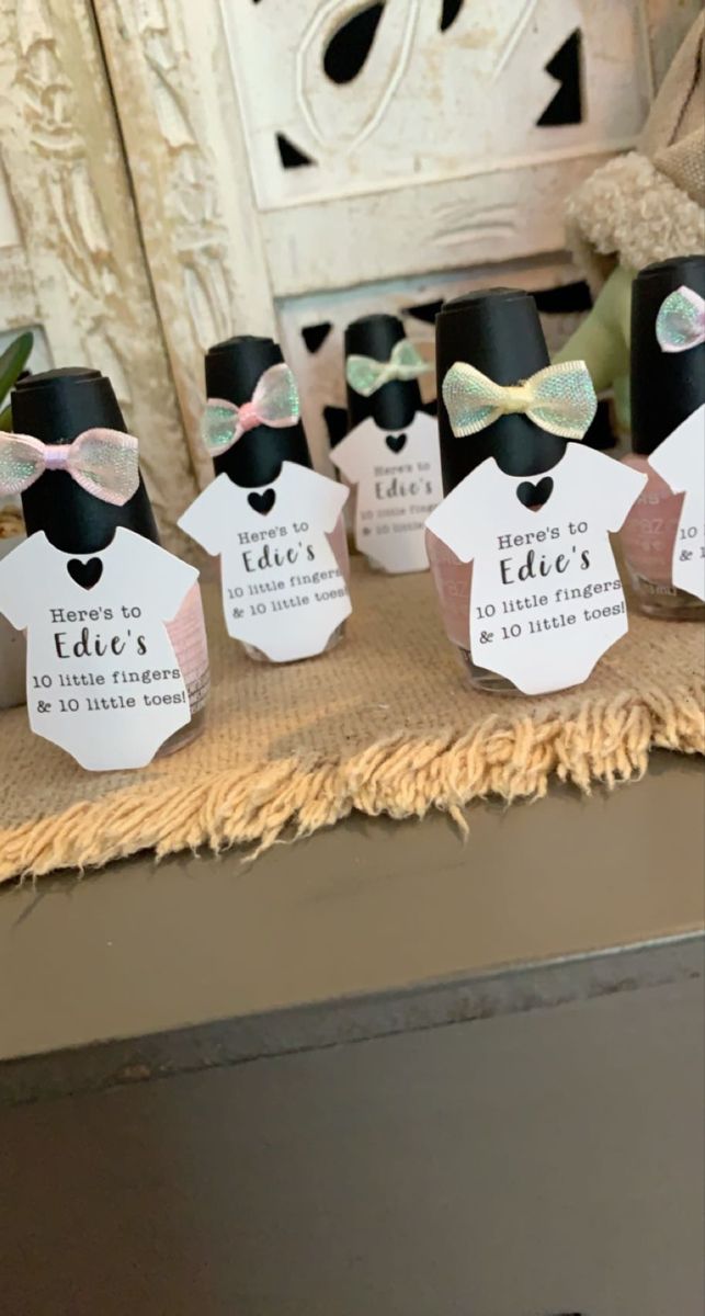 small black and white paper tags with bow ties on them sitting on a table in front of a window