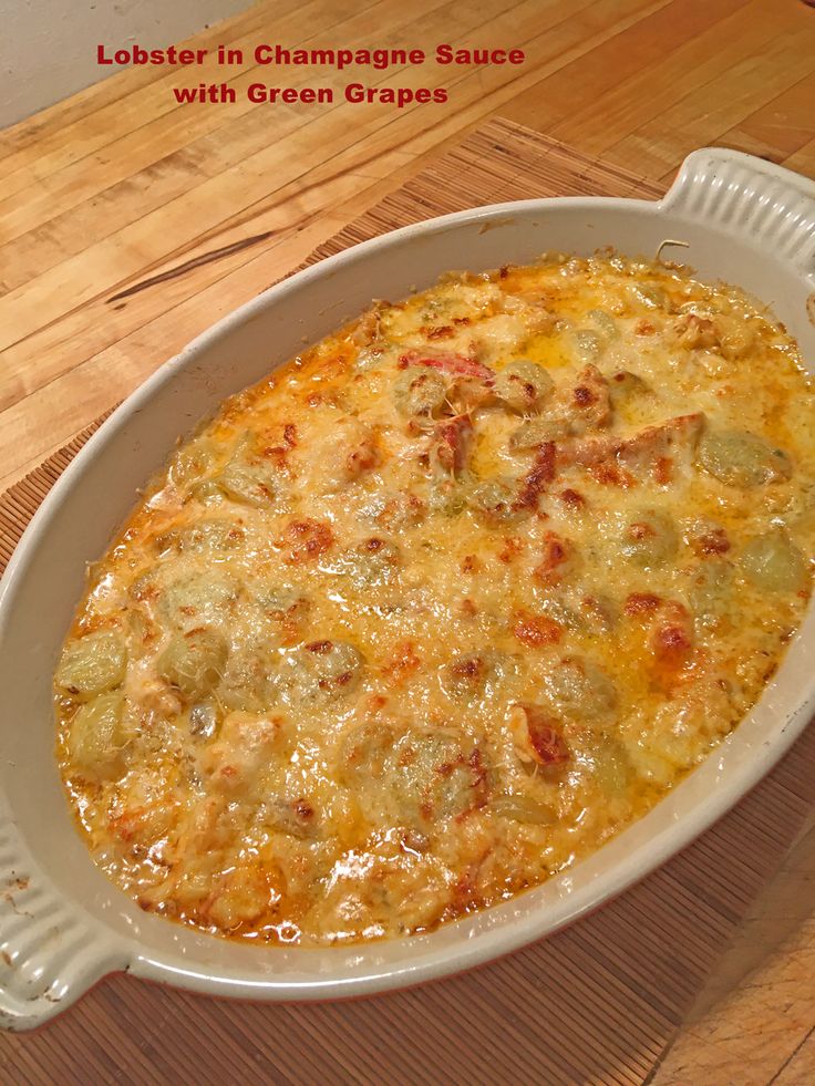 a casserole dish on a wooden table with the words lobster in champagne sauce