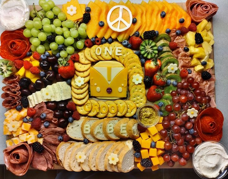 a platter filled with lots of different types of food and peace sign on it