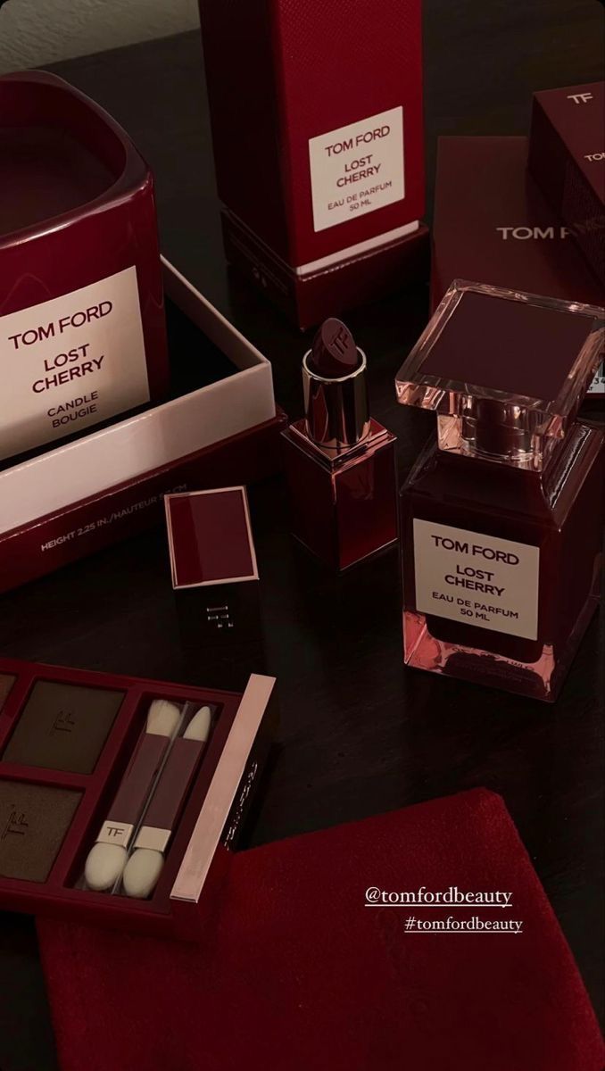 the contents of tom ford's cherry collection are displayed on a table with red velvet