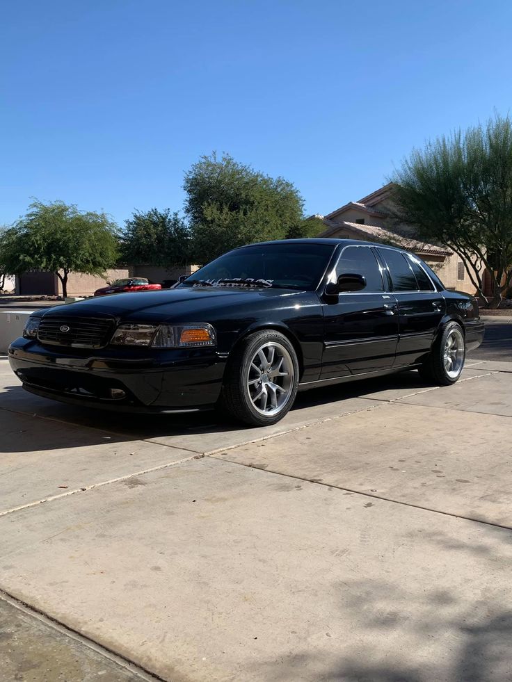 a black car parked in front of a house