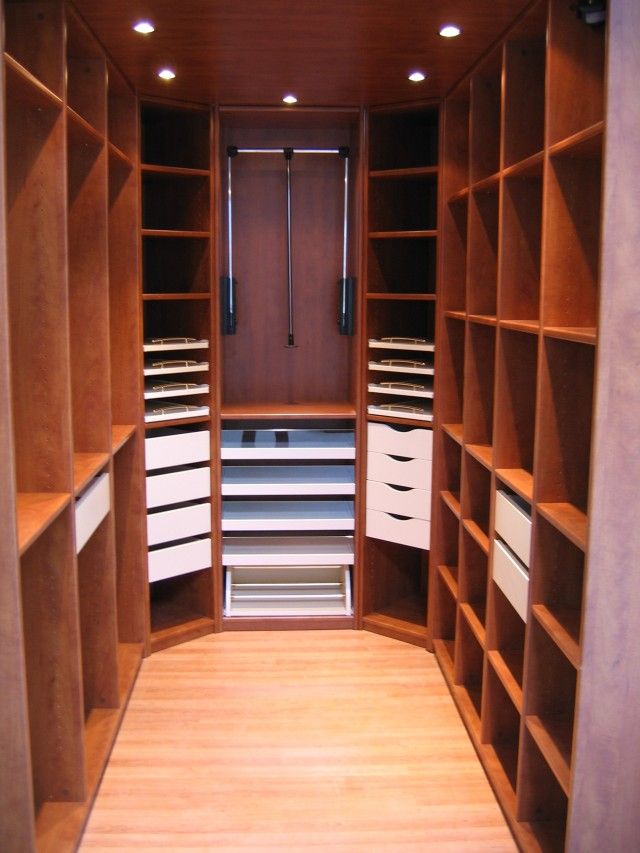 an empty walk in closet with lots of drawers