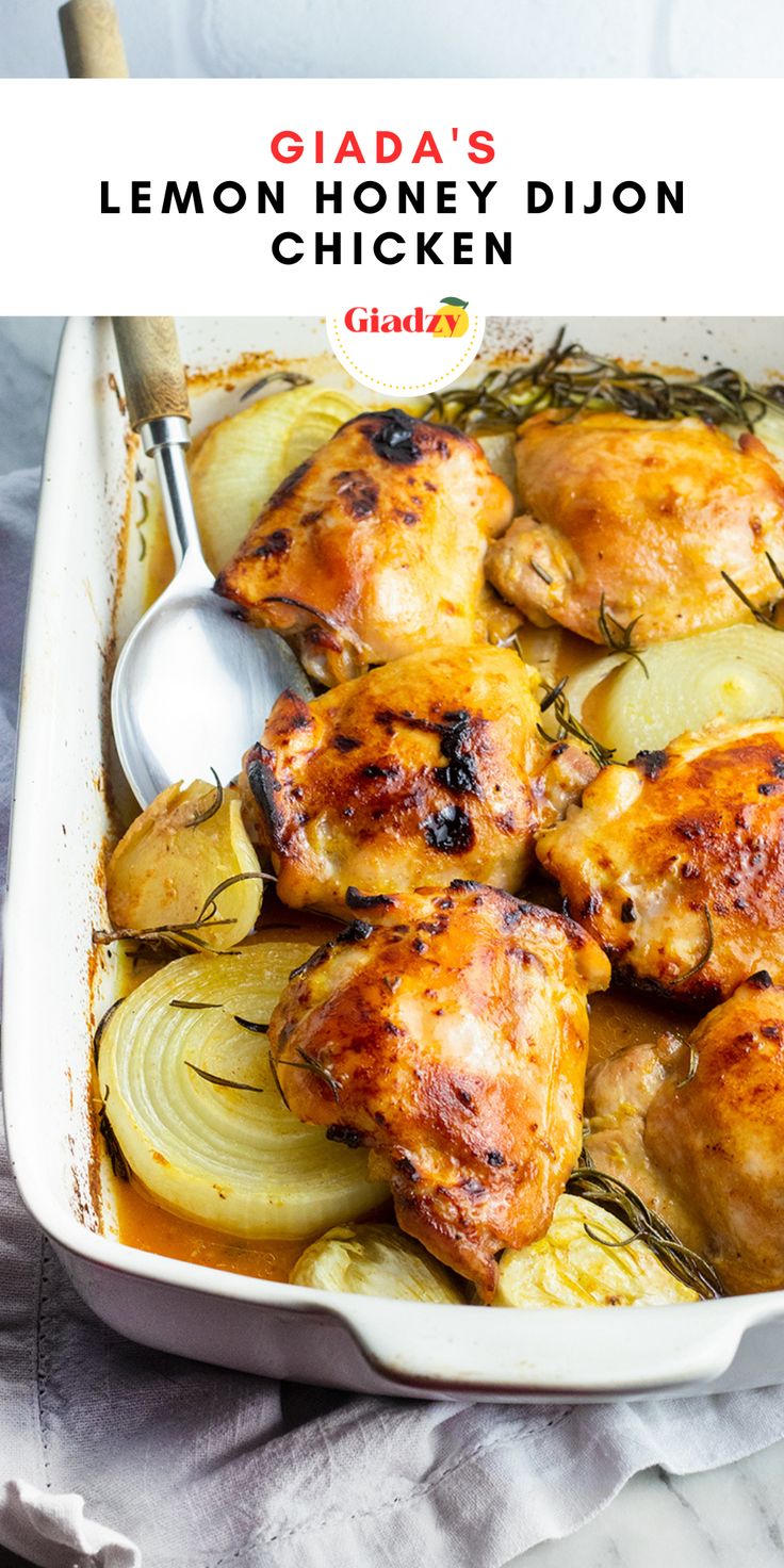 chicken with lemon and onions in a white casserole dish on a gray cloth