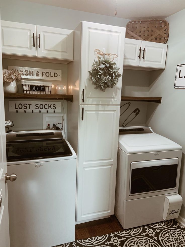 a white washer and dryer sitting next to each other in a laundry room