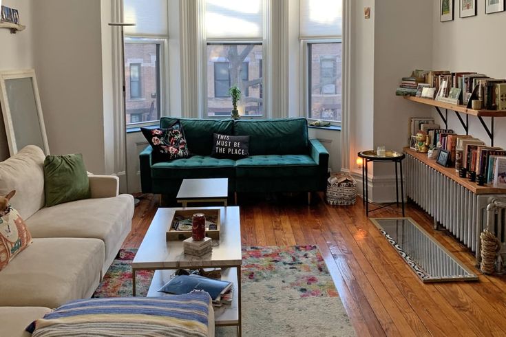 a living room filled with furniture and lots of windows