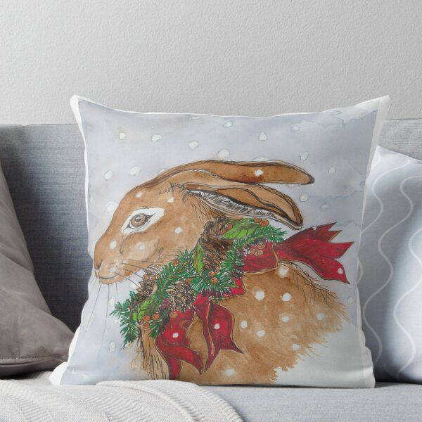 a painting of a brown rabbit with christmas decorations on it's back throw pillow