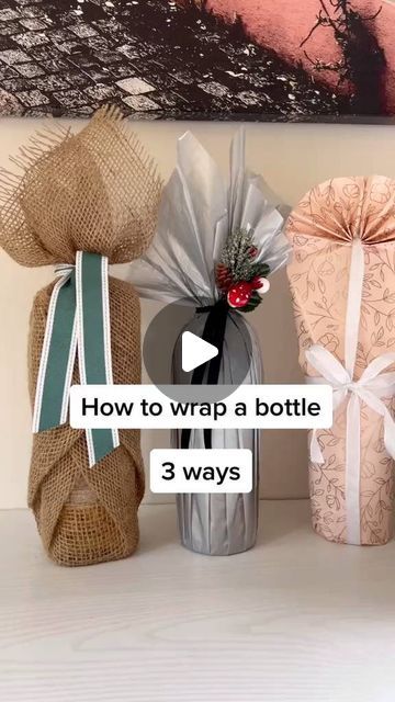 three wrapped gift bags sitting on top of a table next to each other with the words how to wrap a bottle 3 ways