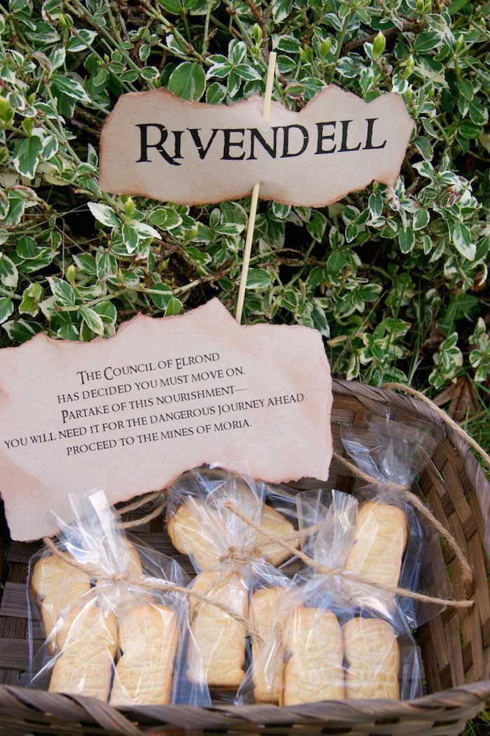 some bread sticks are in a basket on the ground next to a sign that says rivendell