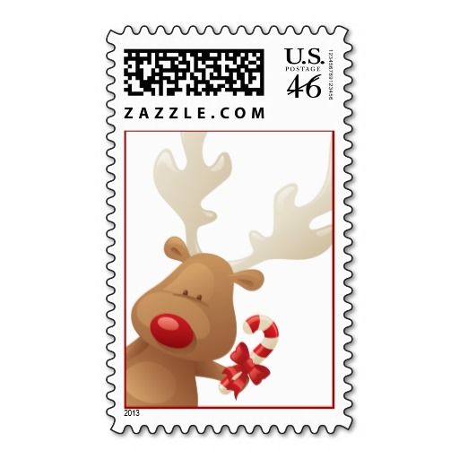 a postage stamp with a reindeer and candy canes in it's mouth, on a white background