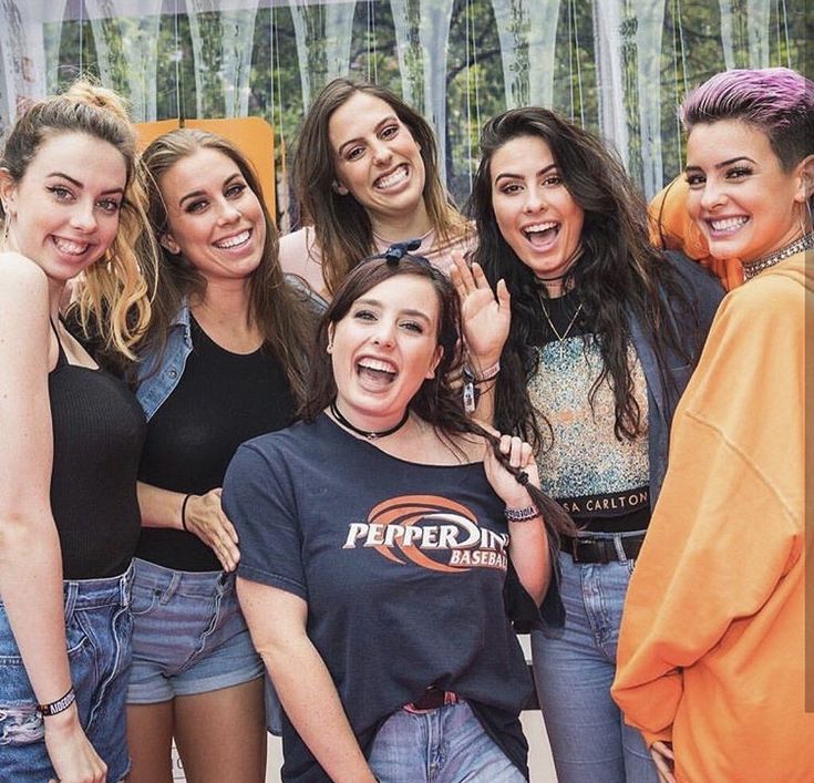 a group of young women standing next to each other