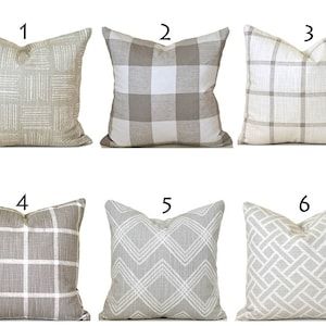 six pillows with different plaid patterns and numbers on them, all lined up in the same row